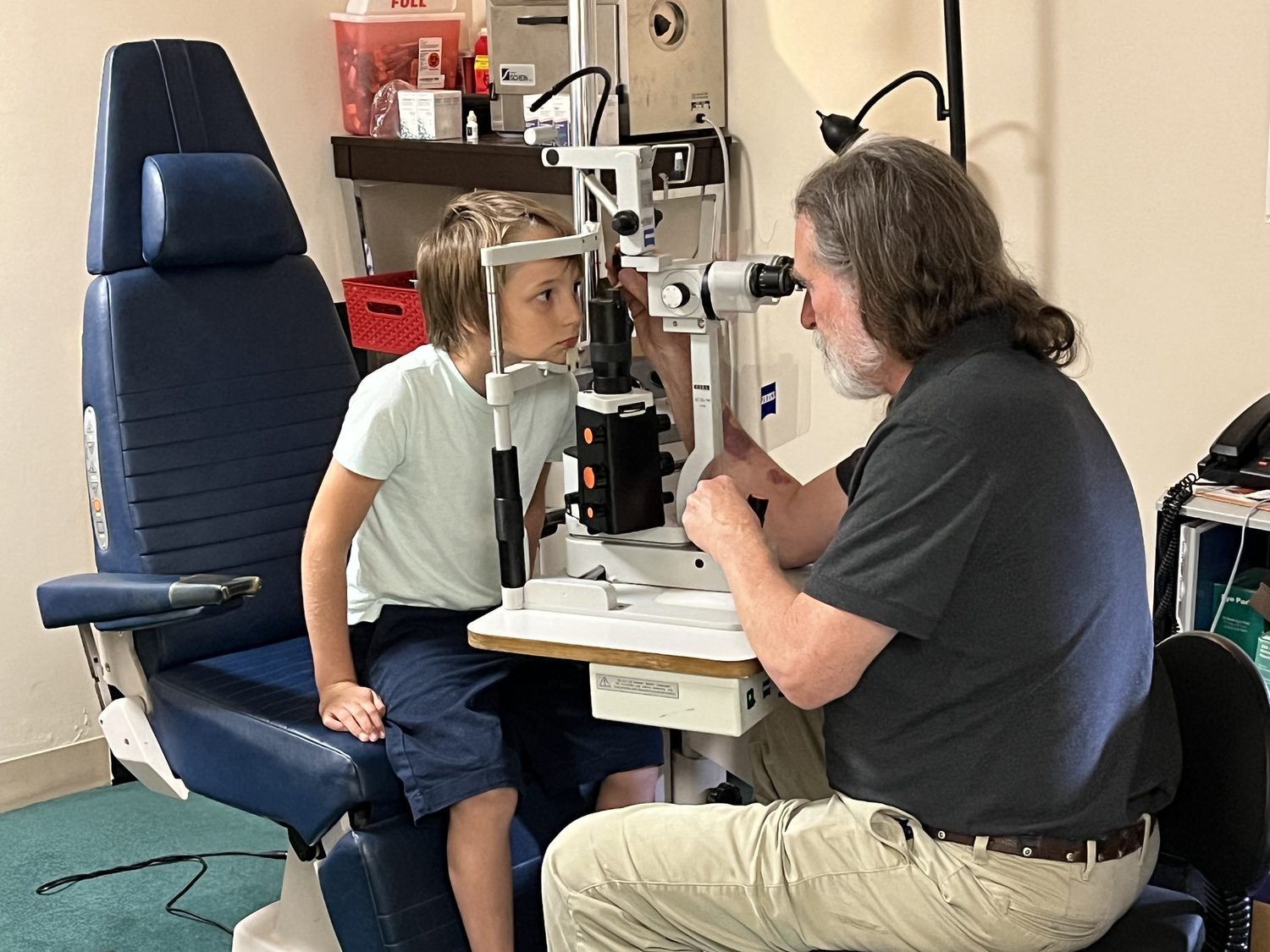 Dr. Carpenter examining a young patient at the slit lamp